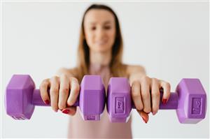 Woman holds hand weights